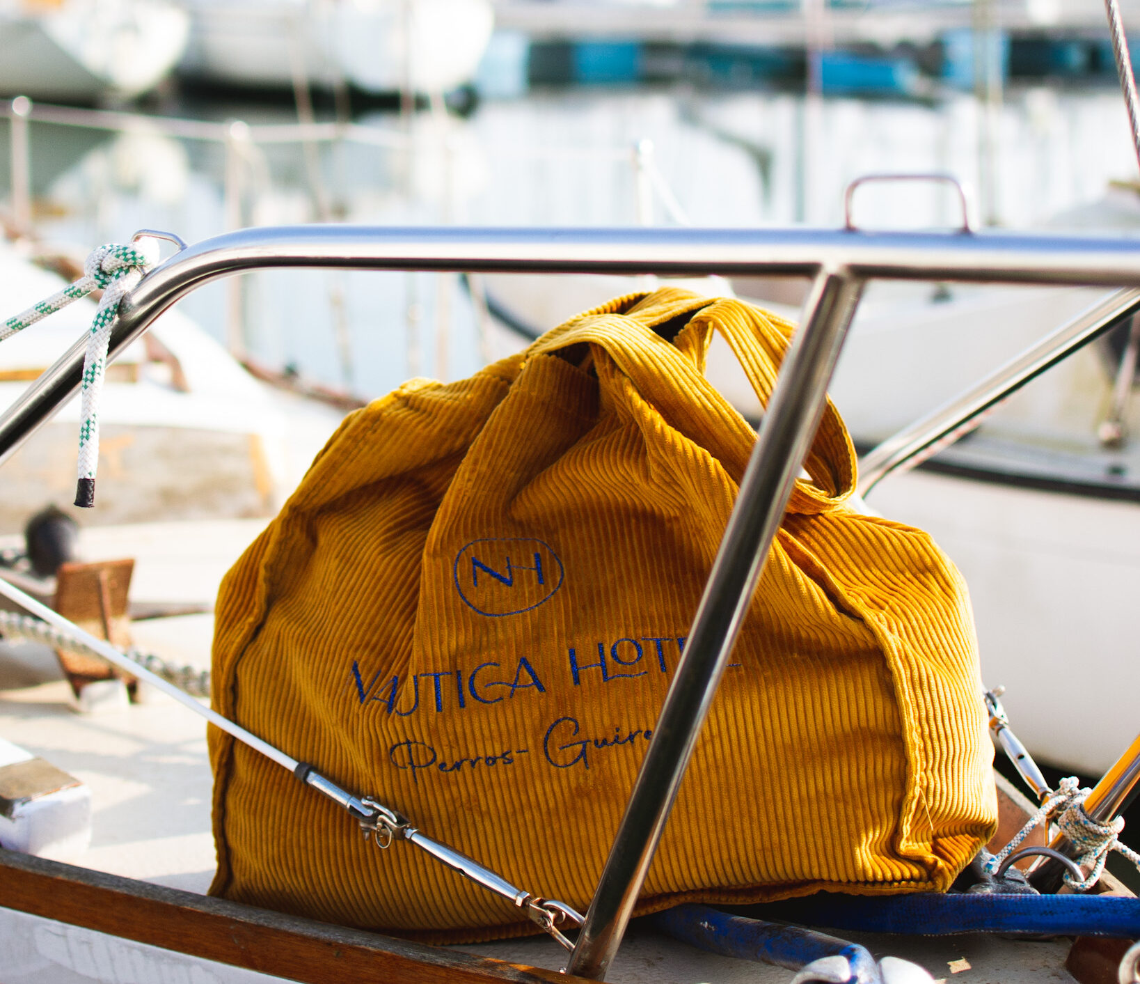 The yellow shopping bag of the Nautica Hotel on a boat in the port of Perros-Guirec